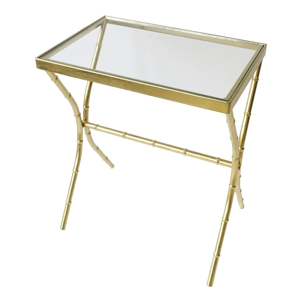 Brass and Glass Bamboo-Esque Side or End Table, Circa 1960s: A convenient, rectangular brass-plated side or end table, circa 1960s, USA. Table's base frame has a modern bamboo-like design and inset glass top. Dimensions: 12.5" D x 18.63" W x 21.25" height.
