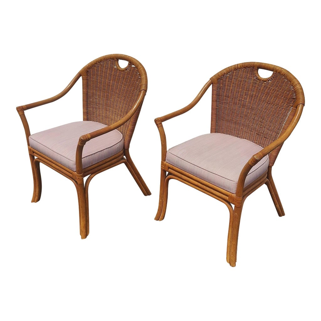 Mid 20th Century Boho Chic Bamboo Rattan and Wicker Arm Chairs - Set of 2: Exceptional vintage boho chic bamboo rattan dining arm chairs. Each feature a wicker back rest with a baby pink fabric seat cushion. Seat height is 18.0 two additional Non-arm chairs sold separately C