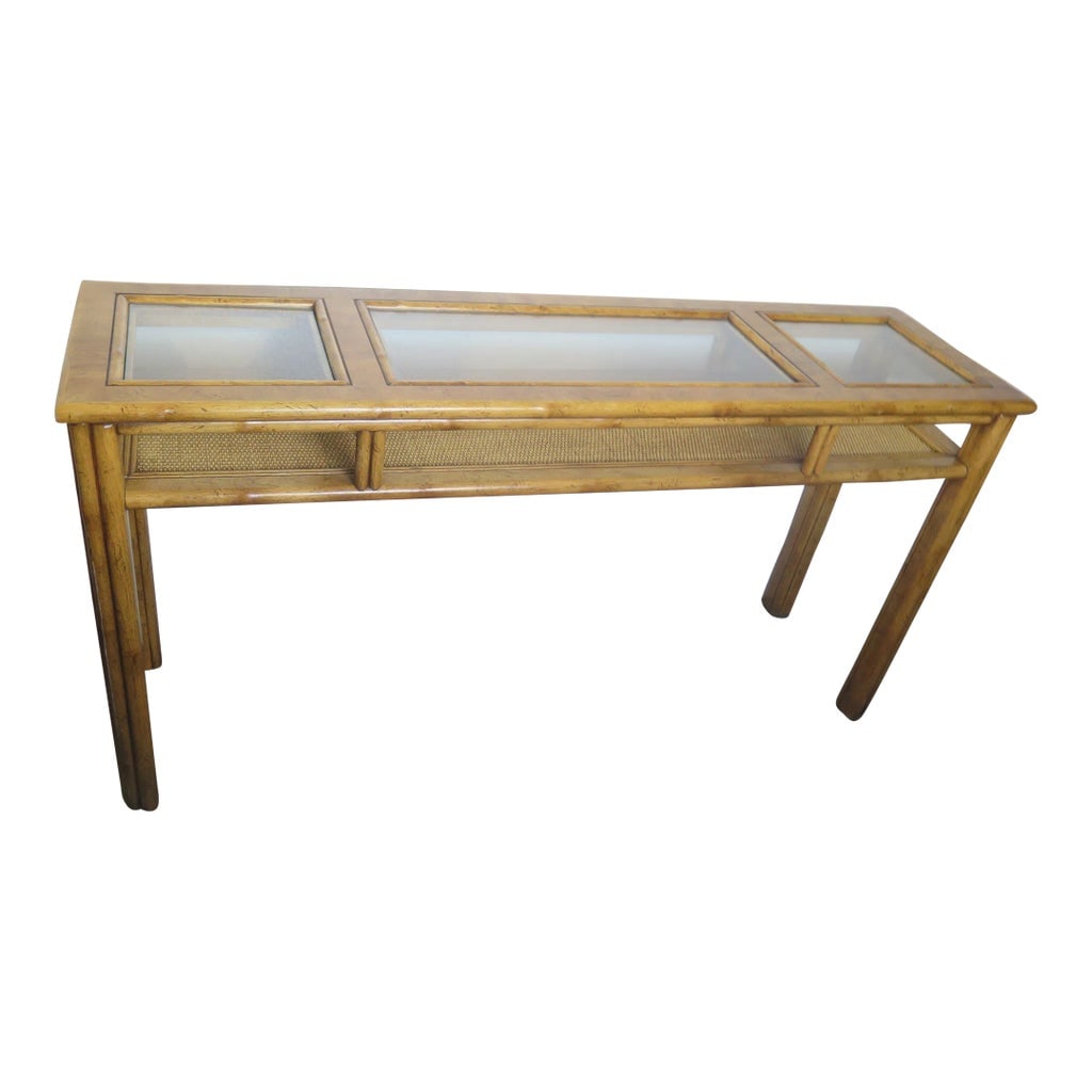 Original Drexel Captiva Collection Faux Bamboo and Woven Rattan Console: This vintage console is the original unaltered Drexel Brand. It is a sturdy faux bamboo and it has a woven rattan lower shelf toped off with glass inlays. It is within the Chinoiserie family. The mode