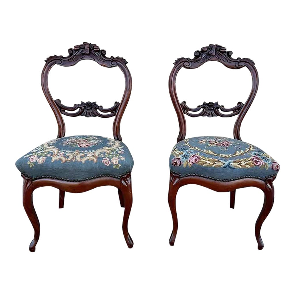 Early 20th Century Pair of Antique Victorian Balloon Back Tapestry Seat Parlor Chairs: Pair of Antique Victorian Balloon Back Tapestry Seat Parlor Chairs Solid wood frame with intricate carvings and embellishments, characteristic of Victorian design, needlepoint seats with brass nail