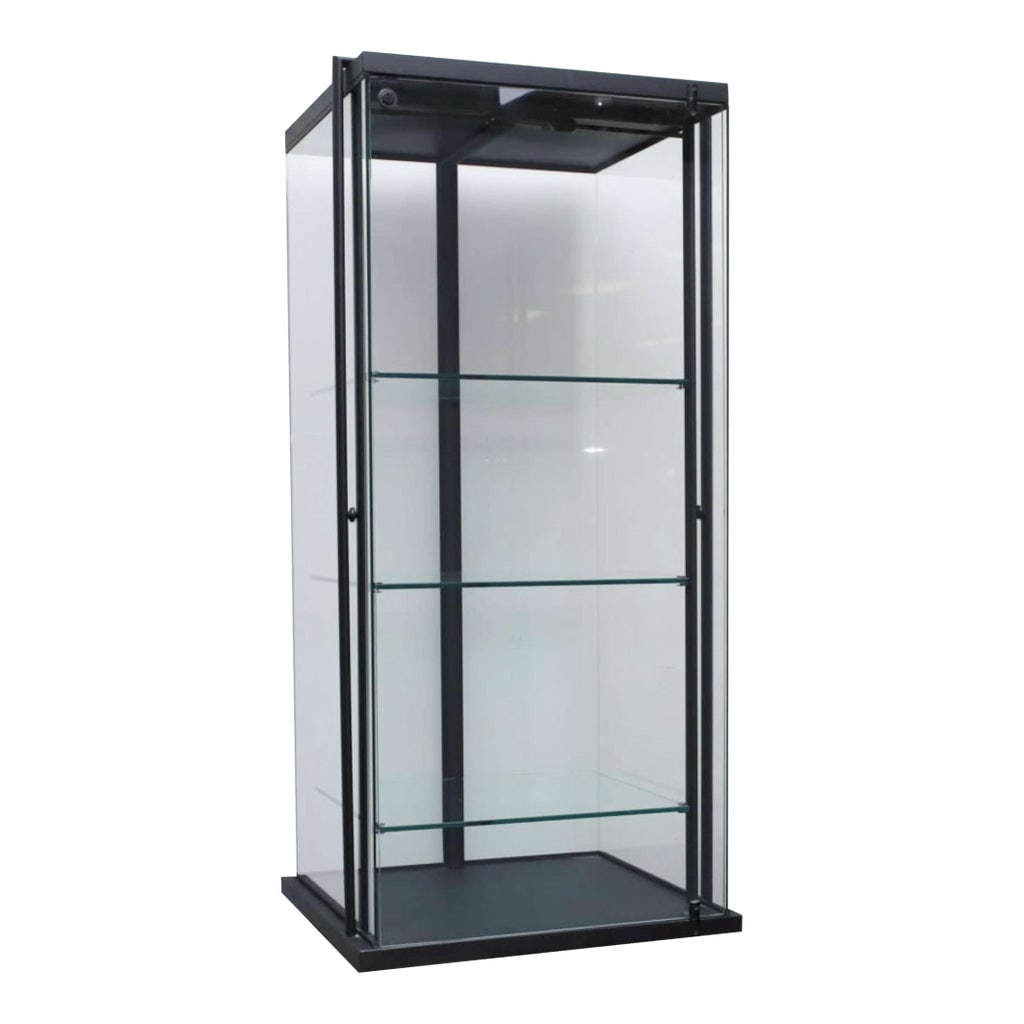 Vintage Black Metal Frame Glass Display Case: This is a vintage black metal framed glass encased display cabinet. It is very(!) heavy and sturdy and has a glass door in the front (with lock and key) and shelves. It sits on unusual designed skinny