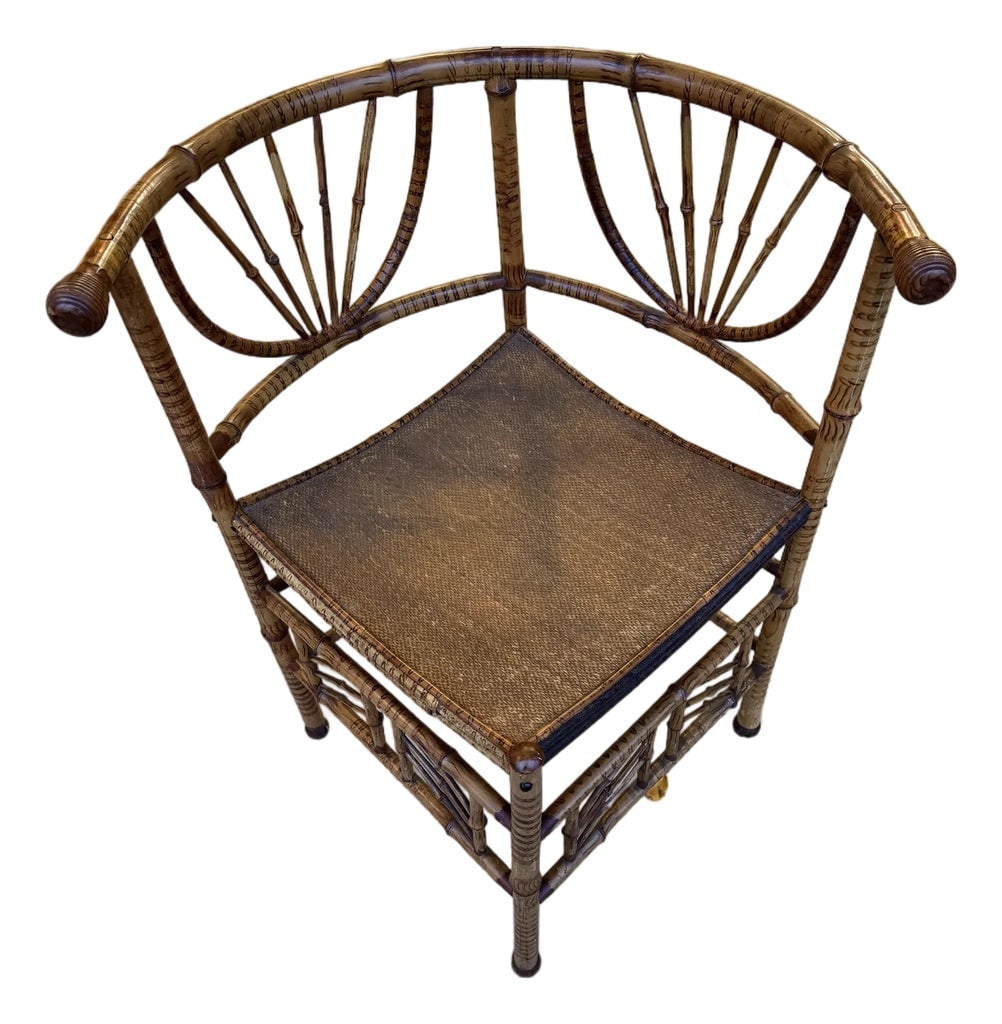 Antique Chinoiserie Bamboo Corner Chair: A beautiful decorative corner chair circa the late 19th century. With a curved back and seat, detailed caning, and mottled pattern, this is a distinctive accent to any room. Condition: Alterations: Or