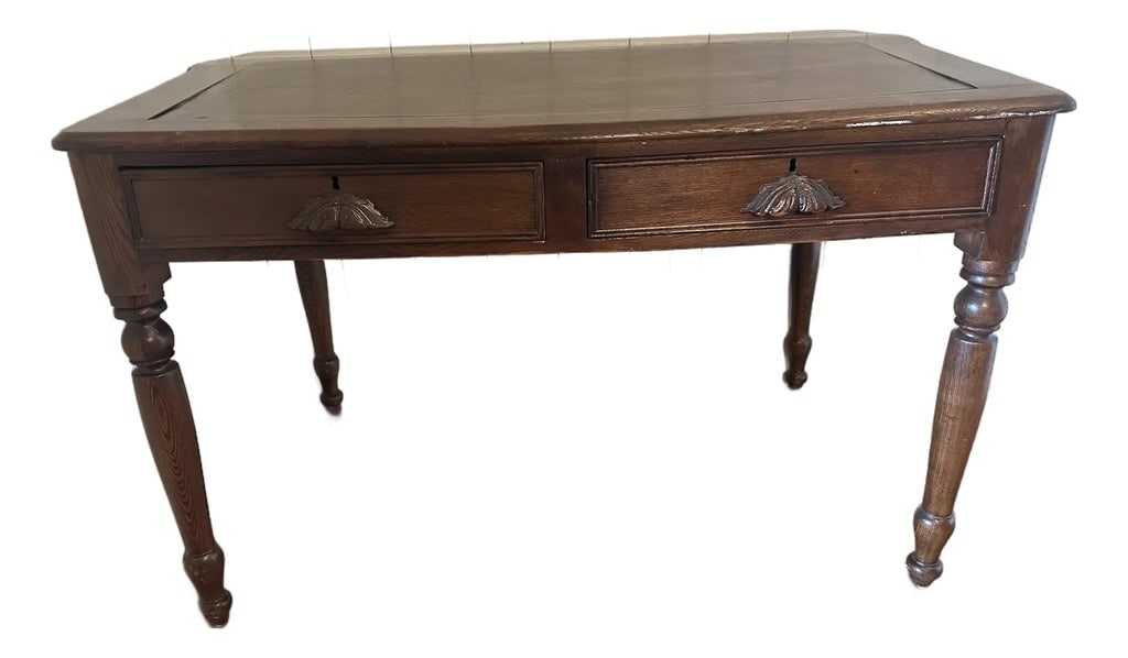Antique Oak Slant-Top Writing Desk, Colonial Revival, C. 1900: Solid oak slant-top writing desk, circa 1900. Features two drawers with carved fan escutcheons and original keyholes, turned legs, and a gently sloped top (32.5"H at back, 30"H at front) designed for