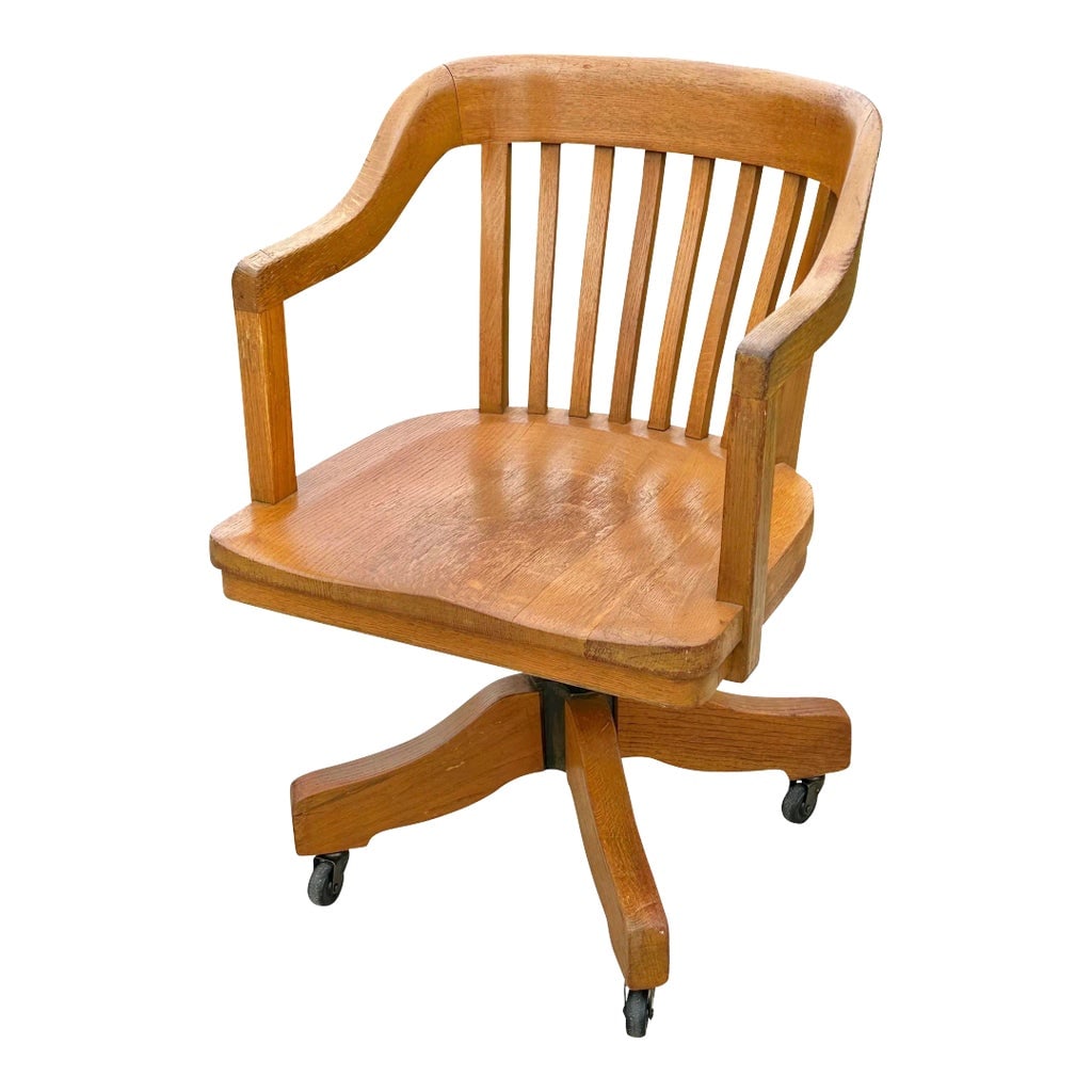 Late 19th Century Antique Victorian Oak Bank of England Arm Chair With Curved Seat & Caster Wheels: With our compliments Bay Colony Antiques takes the distinct pleasure in offering this wonderful antique oak office chair. We are always in pursuit of fine antique desk chairs to accompany any of the