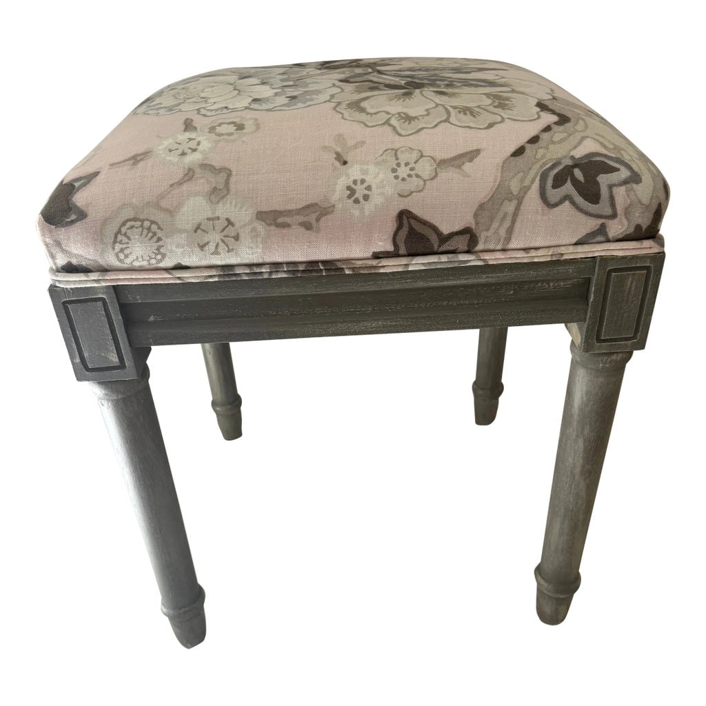 Upholstered Accent Vanity Stool Seat in Schumacher Bermuda Blossom Blush Fabric: Pretty vanity stool with Schumacher's Bermuda Blossom fabric used on it with a double welt finishing. Frame of stool is a weathered gray finish. Stool is prefect for sitting at a vanity or in a