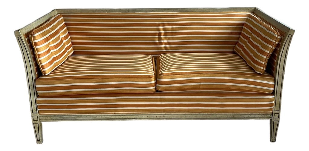 Vintage Caned Upholstered Small Square Sofa: A single vintage rectangular small sofa with four legs and caned sides. The sofa features an upholstered tight back, two seat cushions, and two loose arm cushions. Upholstered in a horizontal striped 
