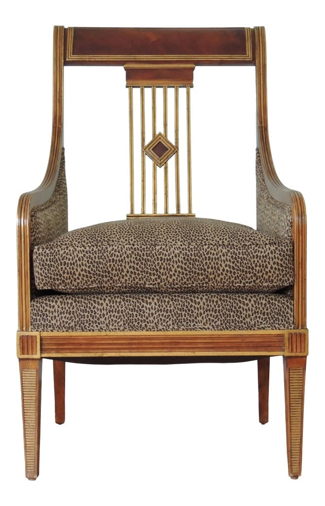 Leopard Print Hollywood Regency Accent Chair: This accent chair has a carved wooden frame with leopard print upholstery and double welting. The backrest features vertical rod shaped structure with a diamond shaped center. The gold accents through