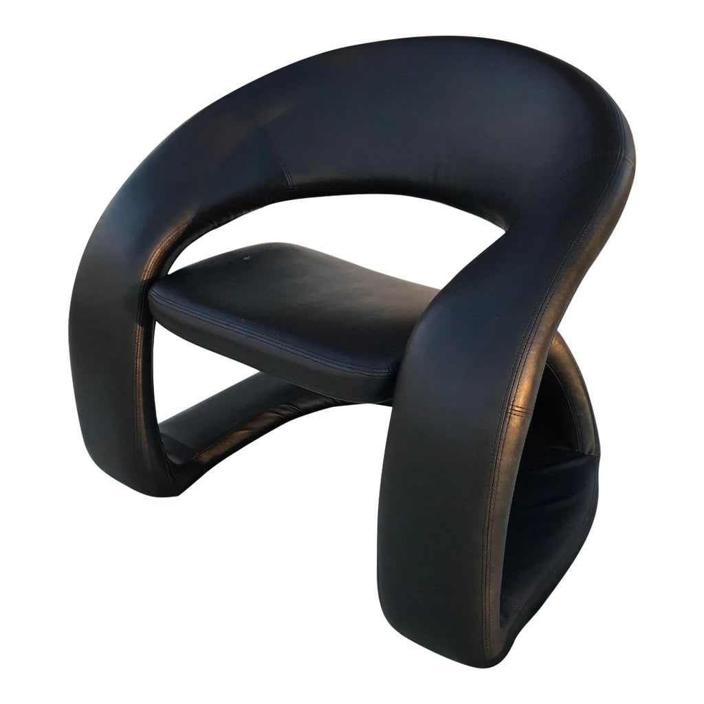1990s Postmodern Sculptural Cantilever Tongue Chair: Iconic sculptural 1990s pop art "tongue" or "ribbon" chair in black faux leather attributed to Pierre Paulin for Jaymar Furniture. There is some wear consistent with age, mostly a little bit on the