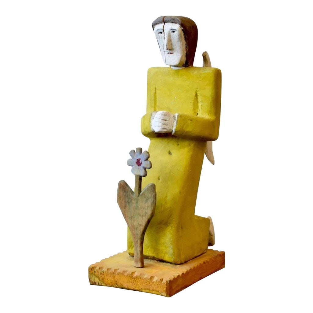 Vintage Folk Art Carved + Painted Wood Figure Praying to Flower by Zenon Miczolek, Circa 1990s: Vintage Folk Art Carved + Painted Wood Figure Praying to Flower by Zenon Miczolek, Circa 1990s. This work depicts a winged angel cloaked in vibrant yellow, praying over a flower. Constructed from