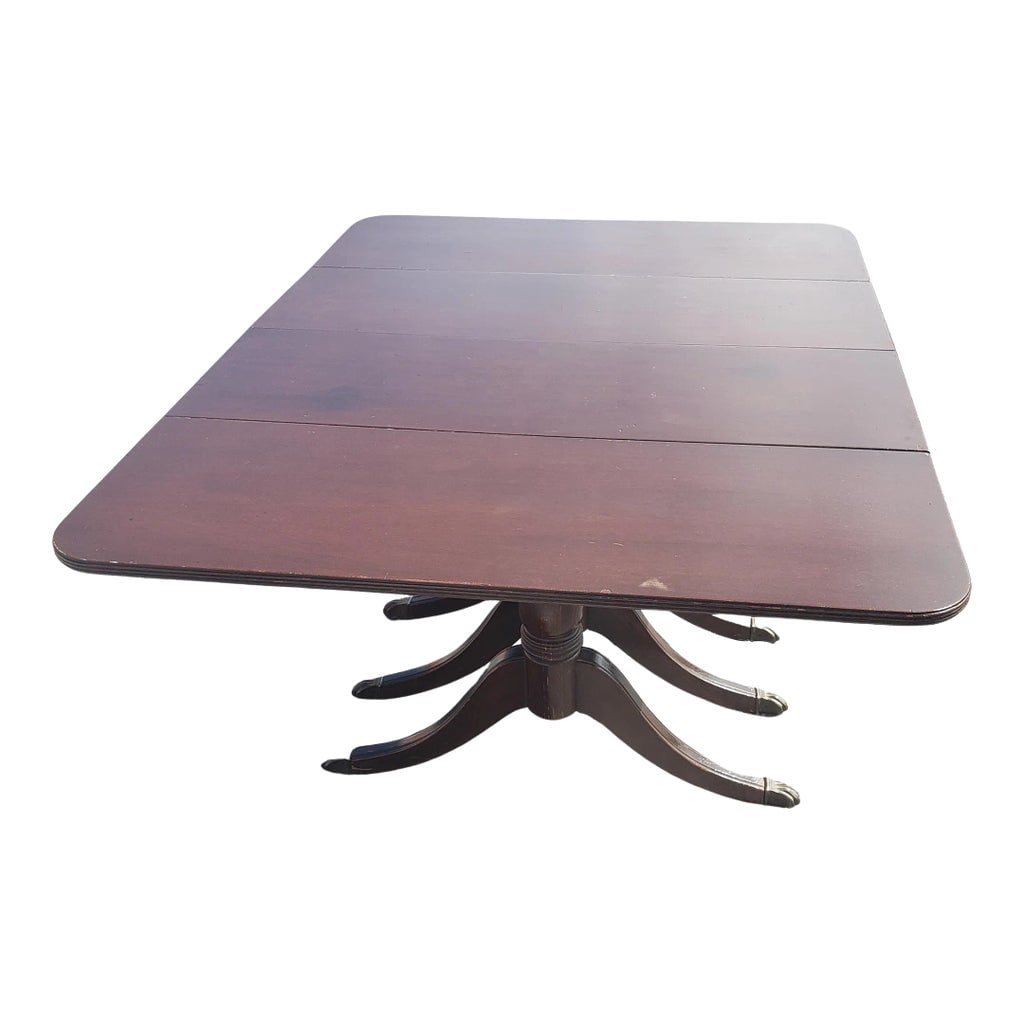 1940s Federal Style Triple Pedestal Drop-Leaf Dining Table: Very practical Vintage Federal Style Triple Pedestal Drop-Leaf Dining Table. Triple pedestal terminating with antique brass lion paw feet. Original finish with age patina. Wear appropriate with age an