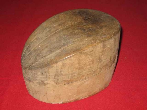 048: Wooden Hat Mold #1 Prince Edward Island : Date: Unknown. Size: 6” wide, 7 ½ long, 4 ¾” tall (15.2 x 17.8 x 12.0 cm). Description: An item selected from the Log Cabin Museum in Murray Harbour, PEI.