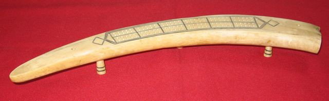 Walrus Tusk Scrimshaw Cribbage Board - 1939: Title: Walrus Tusk Scrimshaw Cribbage Board. Maker: attributed to W. G. Kerr. Date: 1939. Description: Length on outside curve: 19" (48.2 cm). Length on inside curve: 17" (43.1 cm). Width in the middl