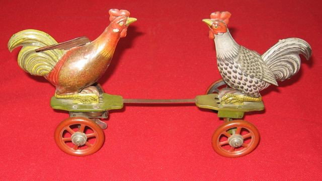 German Cock-fighting Painted Tin Wind-up Toy: Title: German cockfighting painted wind-up tin toy. Maker: Unknown. Date: Unknown. Size: 10” x 5” x 3” (25.4 x 12.7 x 7.6 cm). Description: Marked "Germany" on both roosters. Stamped D.R.P. (Deu