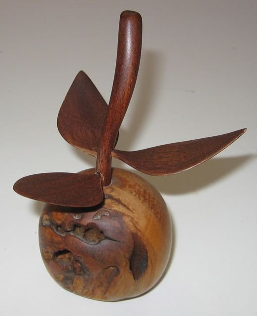 Robert Doddridge Wood Apple Pei Folk Art: Robert Doddridge (Canadian, 1945-2005), “Apple,” c1980. Wood carving measures 6 1/2” tall, by 3 1/4” in diameter. Number 34 stamped on base.