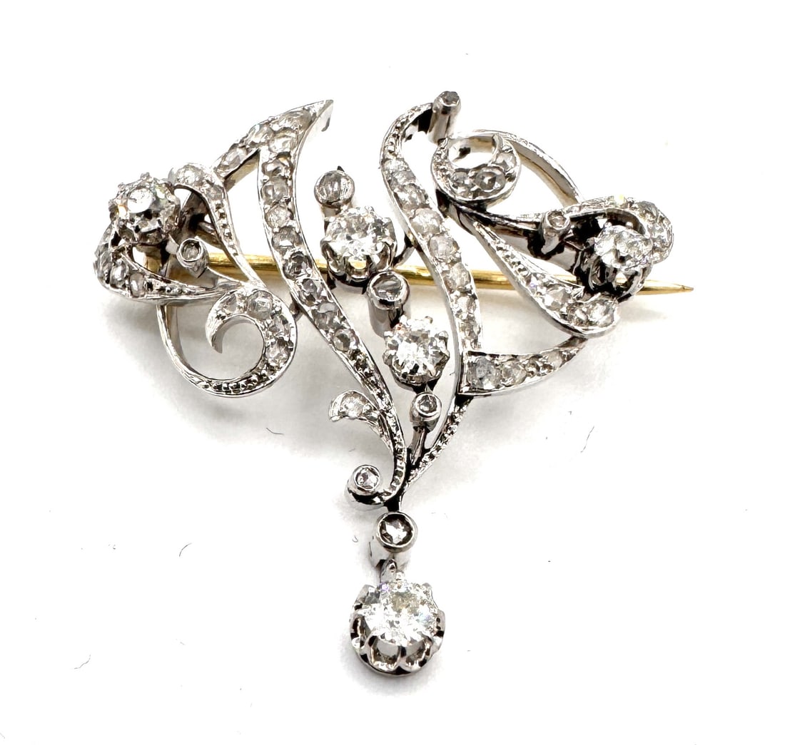 An exquisite and finely articulated antique brooch masterfully pierced geometric "Rosace" in 18k: An exquisite and finely articulated antique brooch, dating from the early 20th century. Masterfully crafted in 18k white gold (750/1000), the design features a sophisticated square-form "Rosace" silho