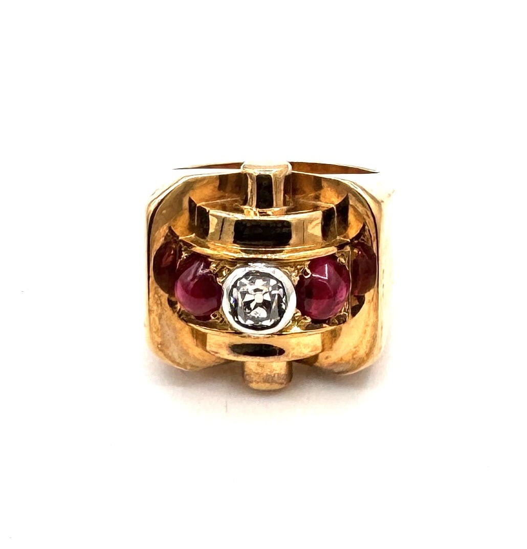 A RUBY-SET "SERPENT" COIL RING A bold zoomorphic statement in 18k gold: An impressive and substantial "Serpent" wrap ring, masterfully crafted in 18k yellow gold (750/1000). This piece features a dual-coil design, with the body of the snake meticulously textured to simula