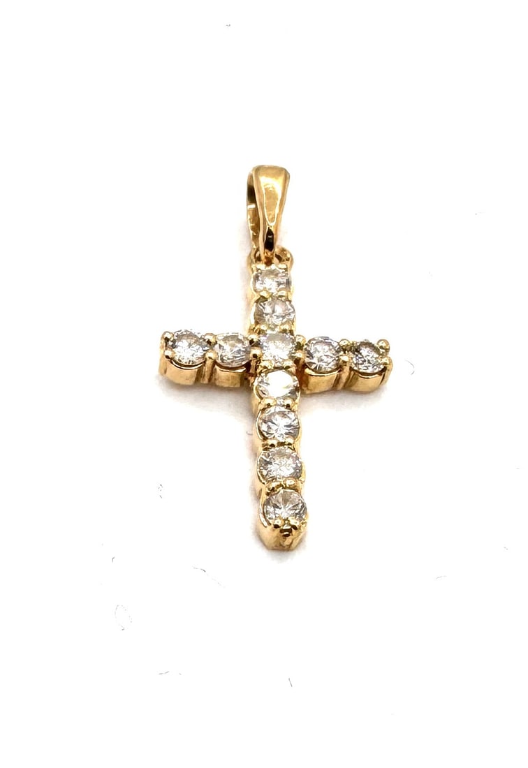 A FINE DIAMOND CROSS PENDANT A classic "Brilliant-Cut" cruciform in 18k gold: A striking and elegant cross pendant of timeless religious and aesthetic appeal. The piece is meticulously set with eleven round brilliant-cut diamonds, totaling approximately 0.60 carat. E