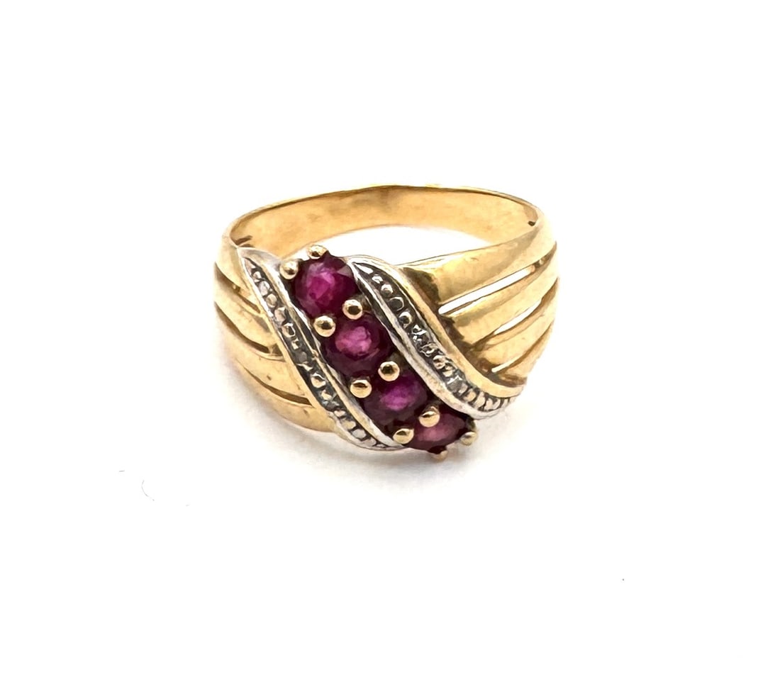 A RUBY AND DIAMOND DRESS RING Of contemporary crossover design in 18k gold: A sophisticated and substantial dress ring featuring a vibrant round-cut ruby as its centerpiece. The ruby is securely held within a multi-prong setting, integrated into a modern "bypass" o