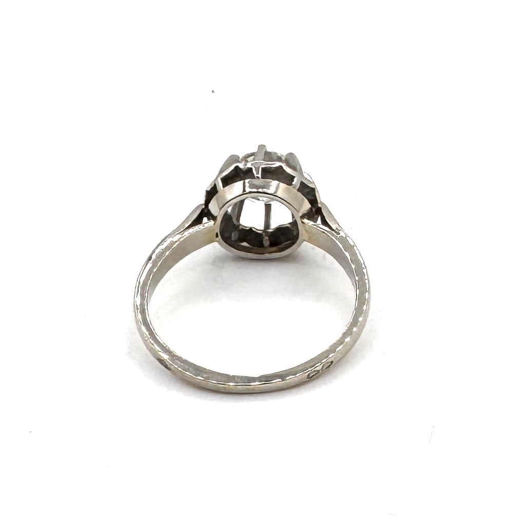 AN EARLY 20TH CENTURY DIAMOND SOLITAIRE RING A classic transitional-cut diamond in a refined 18k: An elegant antique solitaire ring, masterfully crafted in 18k white gold (750/1000). This piece centers upon a significant half-cut (transitional-cut) diamond weighing approximately 1.25 carats. This 