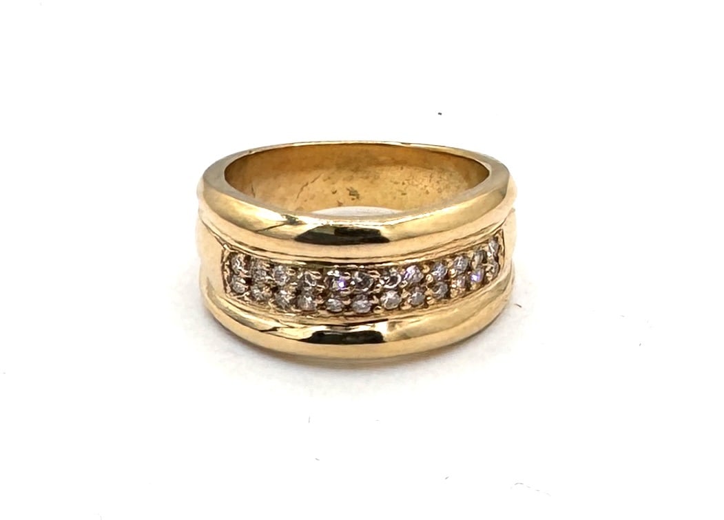 A SUBSTANTIAL DIAMOND SET BAND A bold contemporary statement in 18k gold: A truly impressive and heavy-gauge dress ring, masterfully crafted in 18k yellow gold (750/1000). The design features a broad, convex profile with a high-polished finish, creating a sleek and modern a