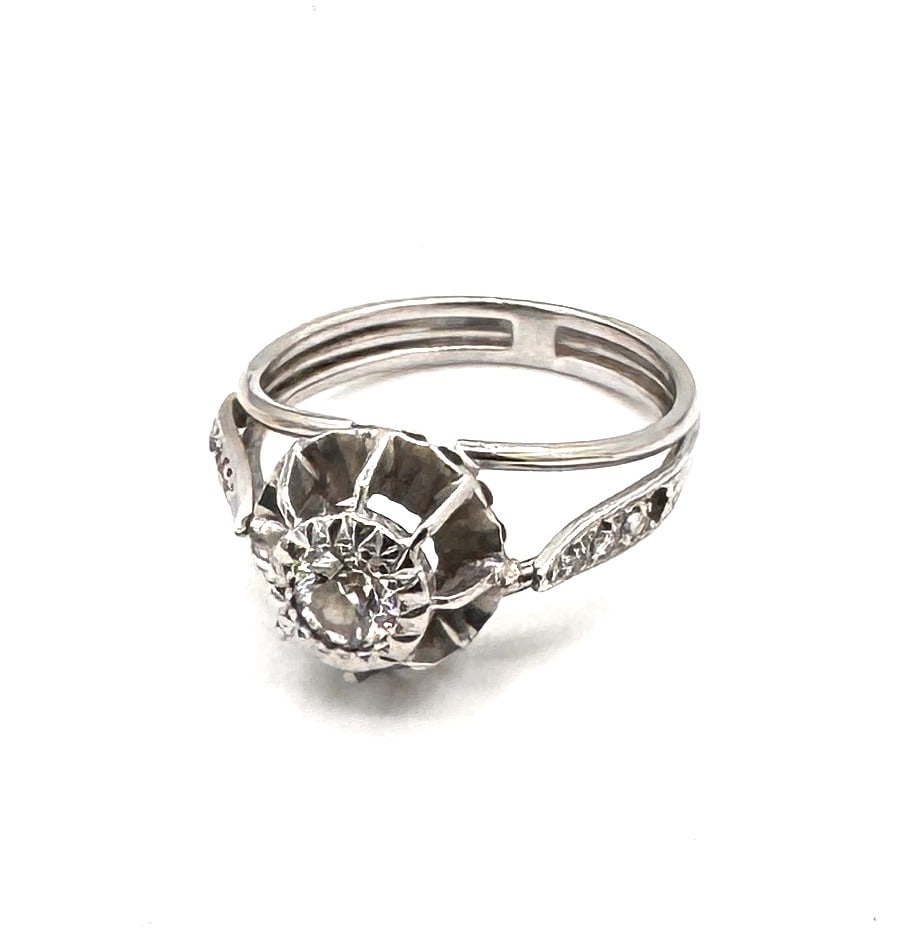 A DIAMOND SOLITAIRE RING A classic brilliant-cut design in 18k gold (1 of 2)