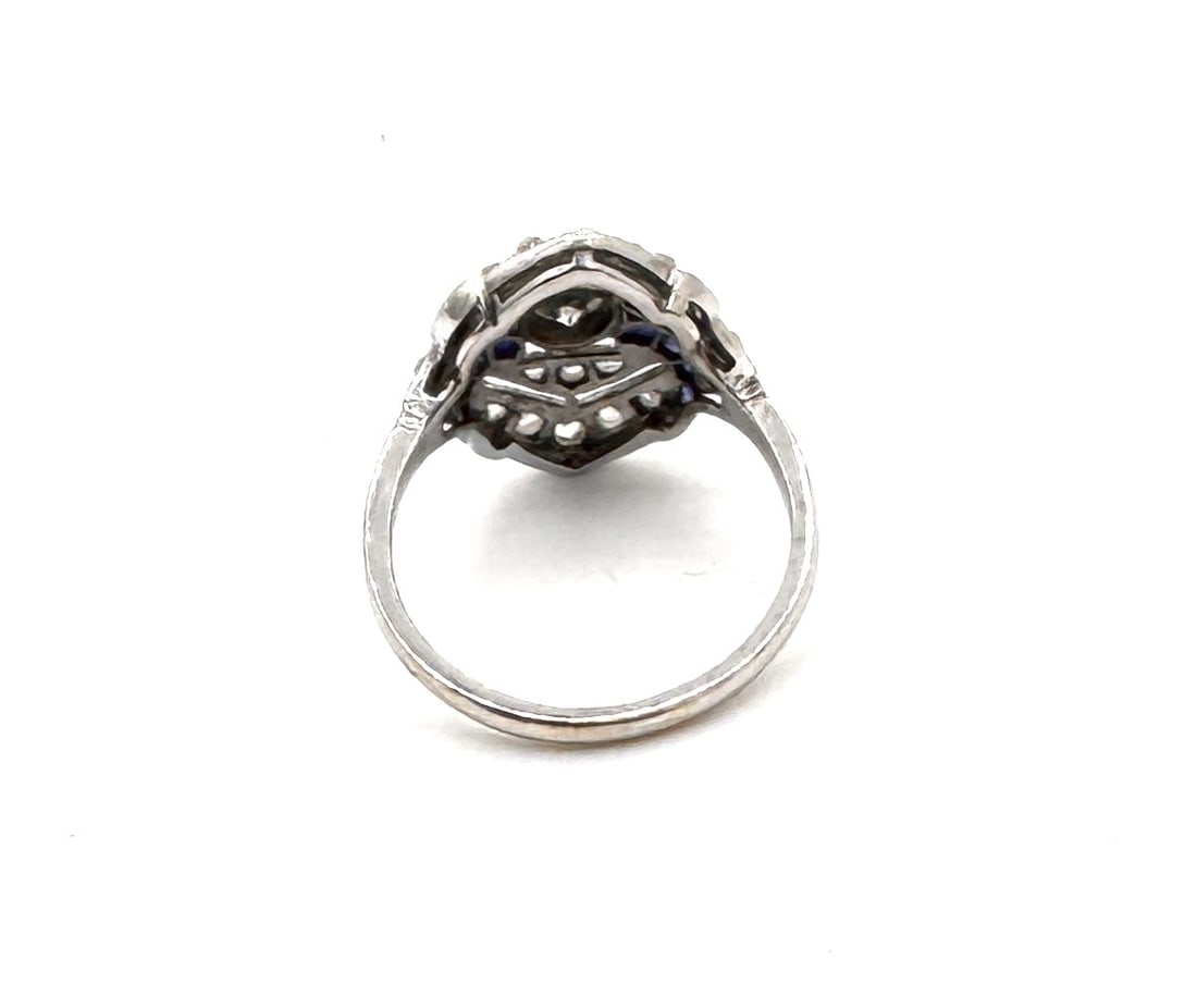 A LATE VICTORIAN SAPPHIRE AND DIAMOND BRIDGE RING A classic five-stone carved hoop design in 18k: An elegant antique "bridge" ring, masterfully preserved and dating from the late 19th to early 20th century. The design features a linear arrangement of alternating gemstones, centering three vibrant 
