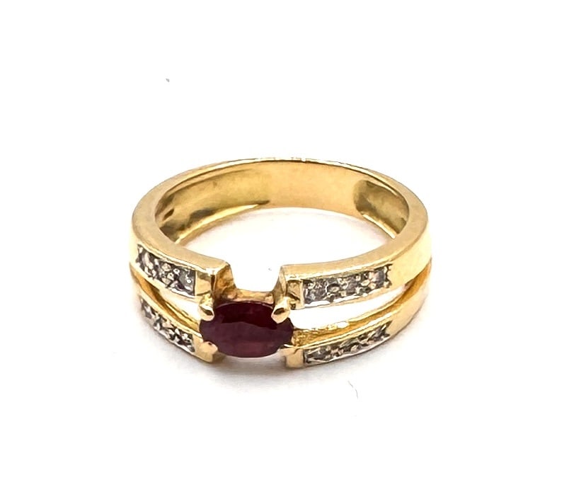 A RUBY AND DIAMOND DRESS RING A contemporary bi-color crossover design in 18k gold (1 of 2)
