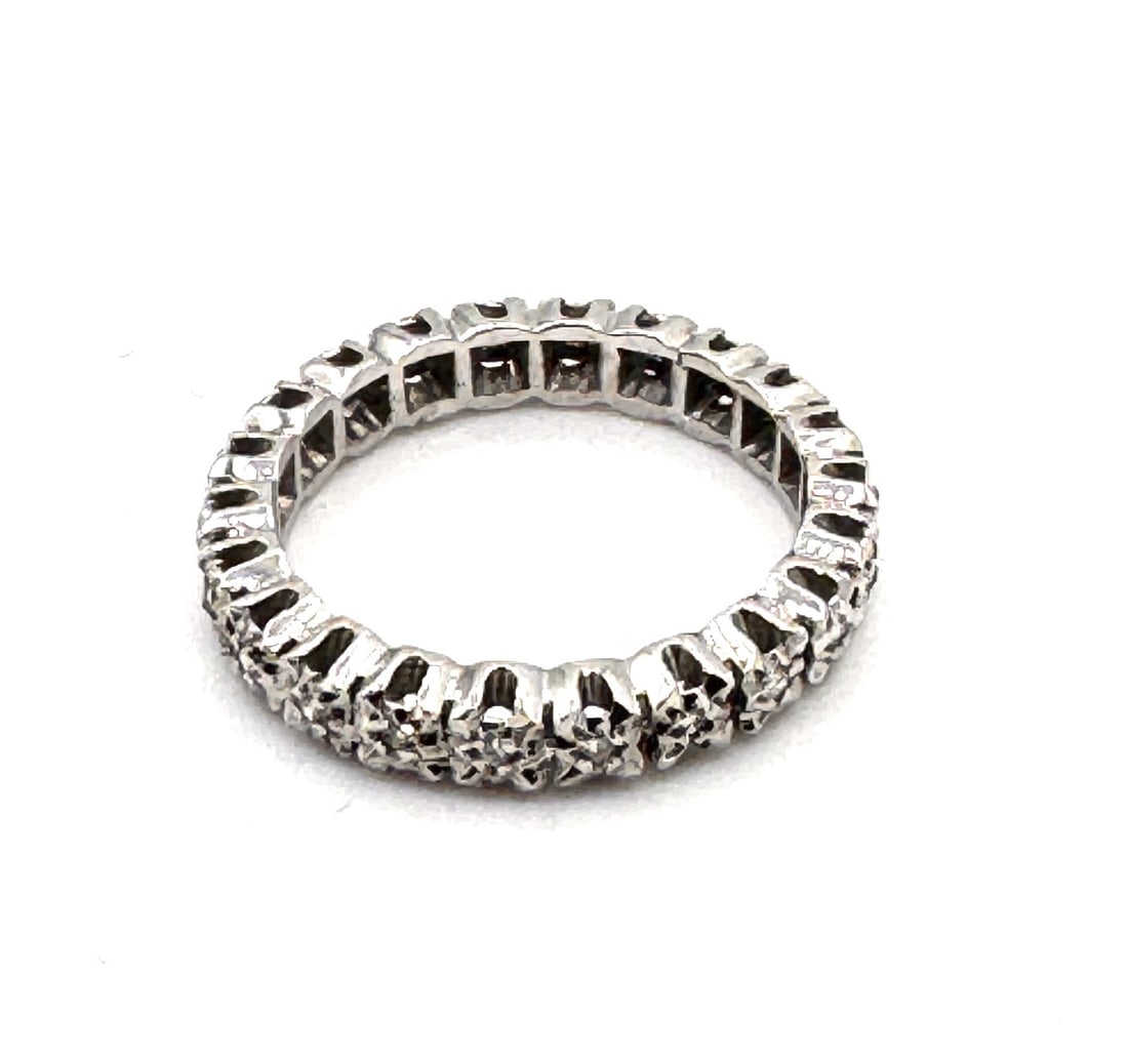 A DIAMOND HALF-ETERNITY BAND A classic "Alliance" ring set in 18k white gold: An elegant and timeless half-eternity band, masterfully crafted in 18k white gold (750/1000). The ring features a continuous row of round brilliant-cut diamonds totaling approximately 0.22