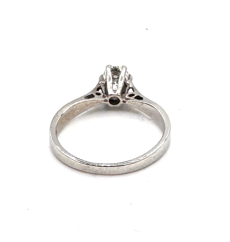 A DIAMOND SOLITAIRE RING A classic brilliant-cut diamond set in 18k yellow gold: A timeless and elegant solitaire ring, featuring a centrally set round brilliant-cut diamond weighing approximately 0.45 carat. The gemstone is held in a traditional six-prong white gold se