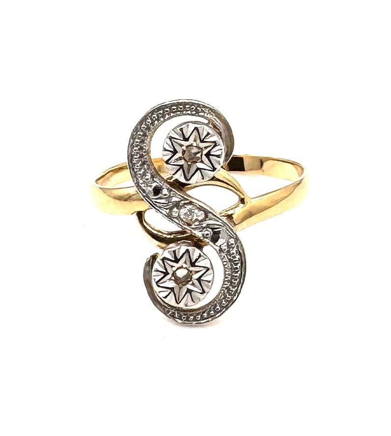 AN ANTIQUE DIAMOND "TOI ET MOI" RING A classic Belle Époque-inspired design in 18k gold: Designed as a traditional "Toi et Moi" (You and Me) ring, symbolizing the union of two souls, this antique piece features two principal old-cut diamonds set in a bypass (cross-over) configuration. Eac