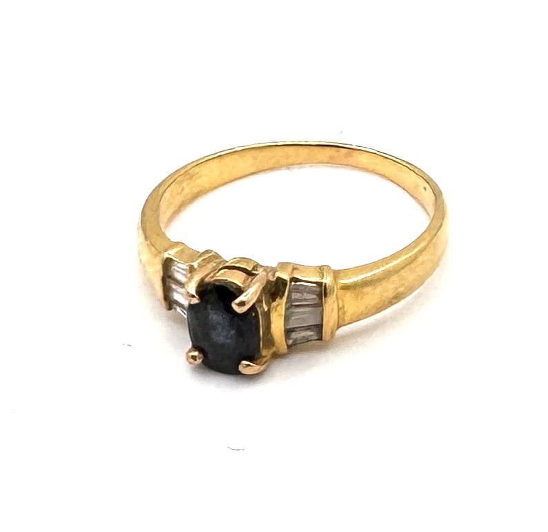 A SAPPHIRE AND DIAMOND DOME RING A bold "Bombe" inspired design in 18k gold: An eye-catching dress ring of textured "Bombe" design, masterfully crafted in 18k yellow gold (750/1000). The broad, domed head is centrally set with an oval-cut blue sapphire, held by four