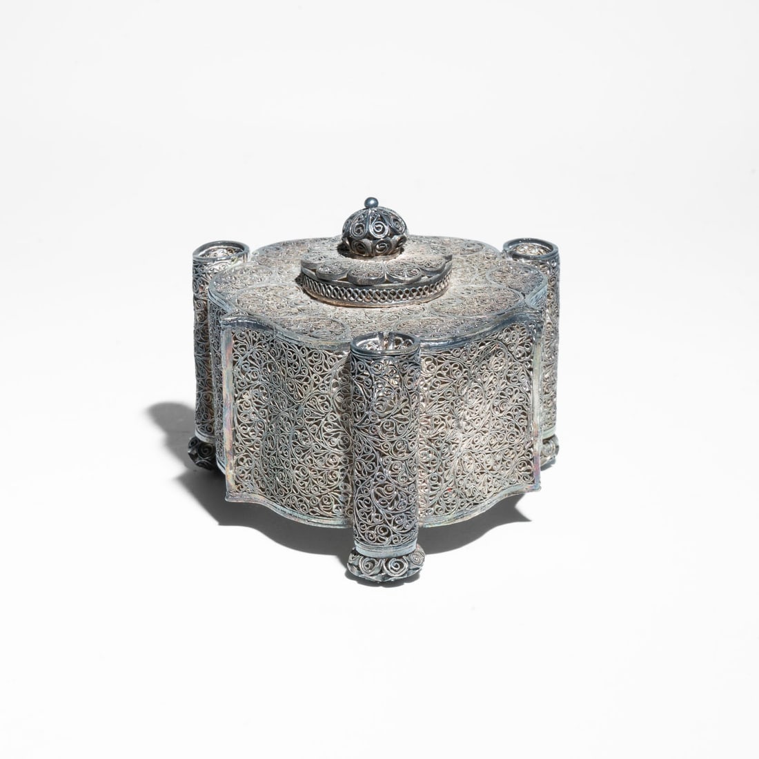 Silver filigree inkwell, Indo-Portuguese or Portuguese 18th Century: It is crafted using filigree, a meticulous art form where fine threads of silver are twisted and soldered into intricate, lace-like patterns. The inkwell features a polylobed or scalloped body. The ce