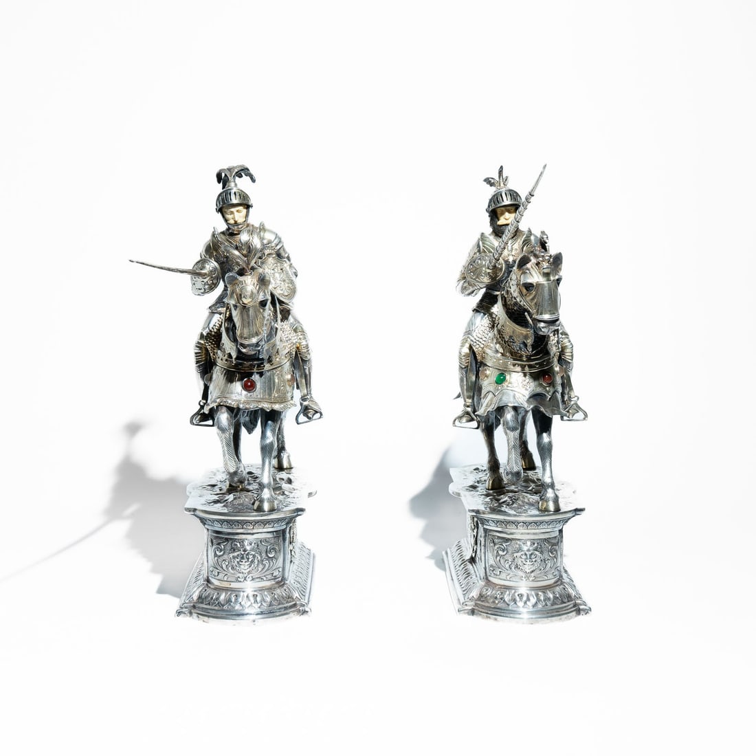2 Silver Chess Pieces of knight figurines on horseback, ivory faces, Hanau Atributted to Neresheimer: They are typically crafted from sterling silver (925) or German silver (often marked .800 or .835). Knight Details: The knight is depicted in full plate armor, often featuring a movable visor and a fa