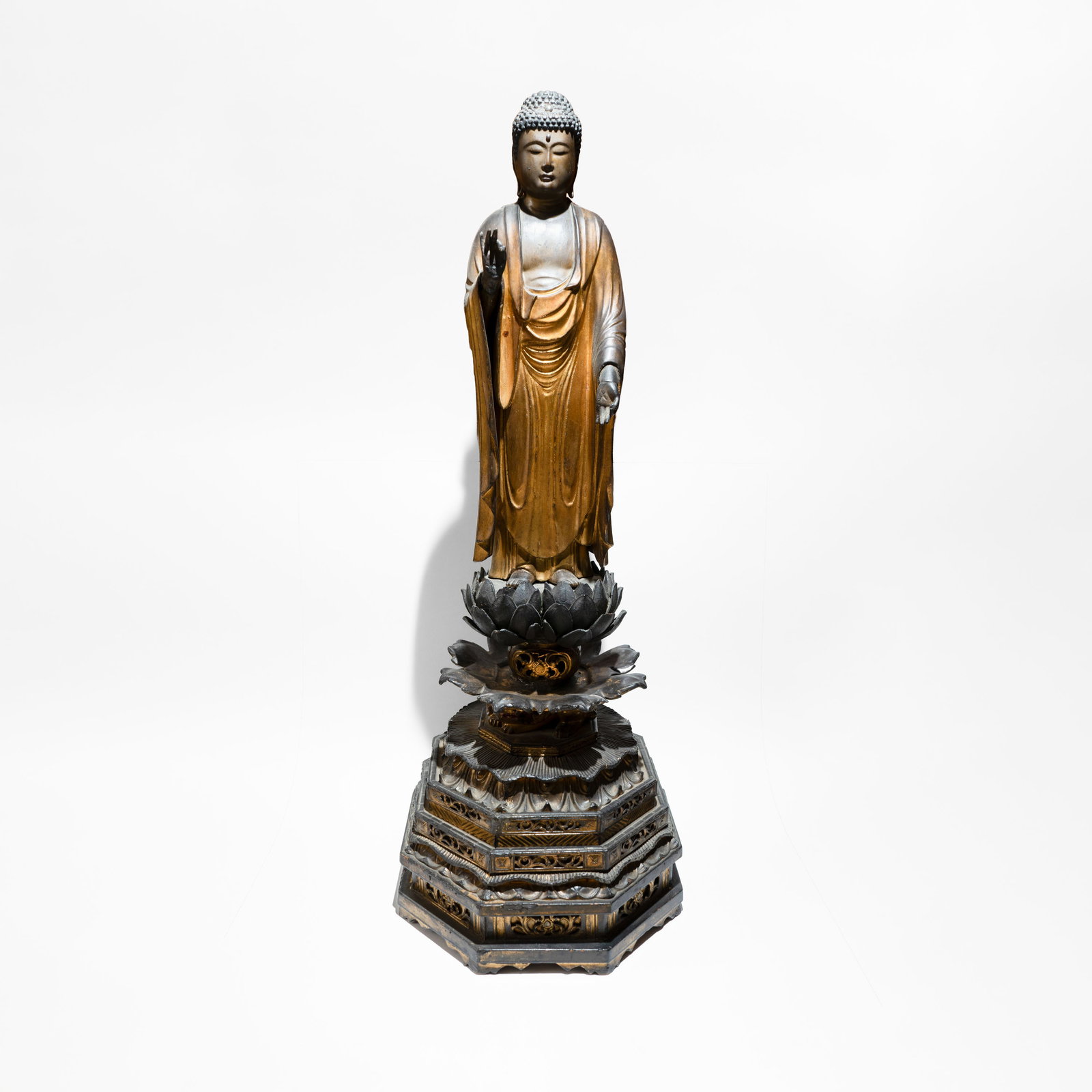 Statue of Amida Buddha in lacquered and gilded wood Edo Period (1603-1867): The Buddha of " Ifinite Light" is depicted standing on a lotus pedestal, often leaning slightly forward as if to reach out to the faithful. Mudra: The hands are typically held in the raigo-in mudra (t