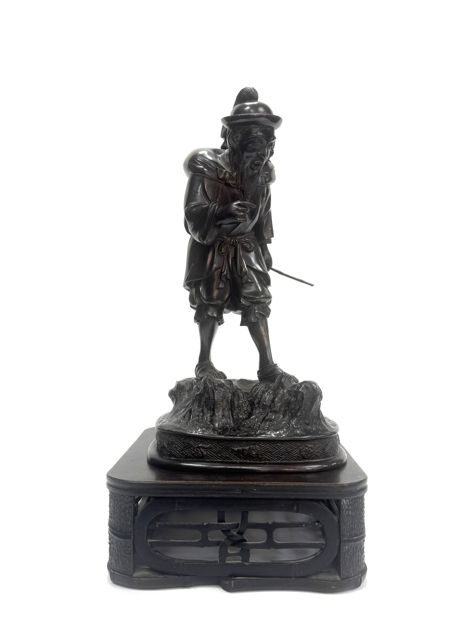 A Fine Bronze Figure Of A Guardian Or Dignitary Vietnam, Nguyen Dynasty, 19th century: This imposing bronze sculpture depicts a standing figure, likely a guardian or a high- ranking court dignitary, rendered with the distinctive aesthetic of the Nguyen dynasty. The figure is portrayed w