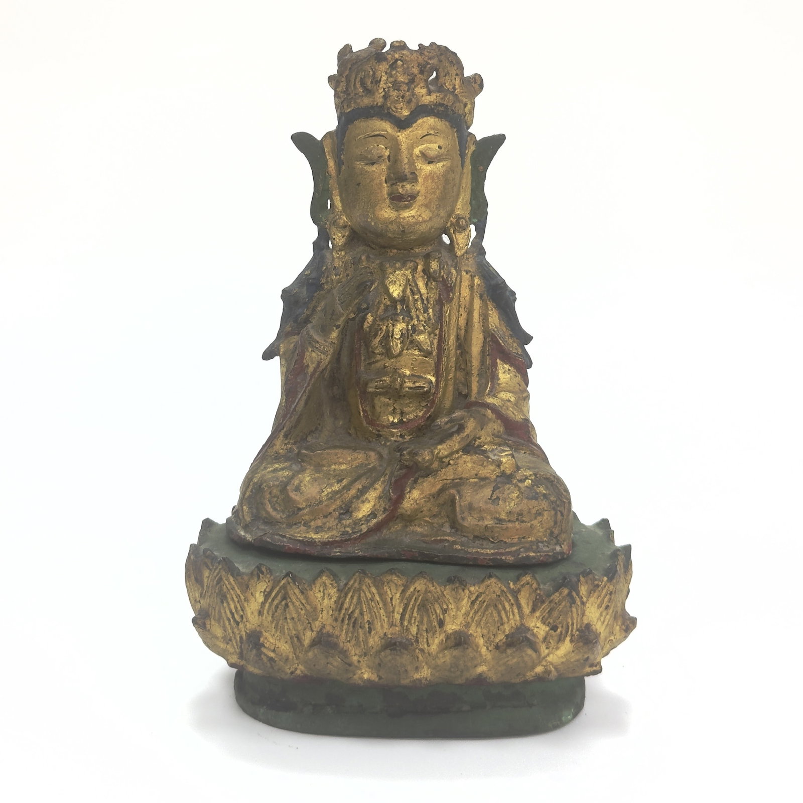 A Gilt And Lacquered Bronze Figure Of Buddha China, Ming Dynasty, 16th - 17th century: The deity is shown seated in dhyanasana on a double-lotus base, with the hands held in bhumisparsha mudra (the earth-touching gesture). The figure is dressed in voluminous robes falling in graceful fo