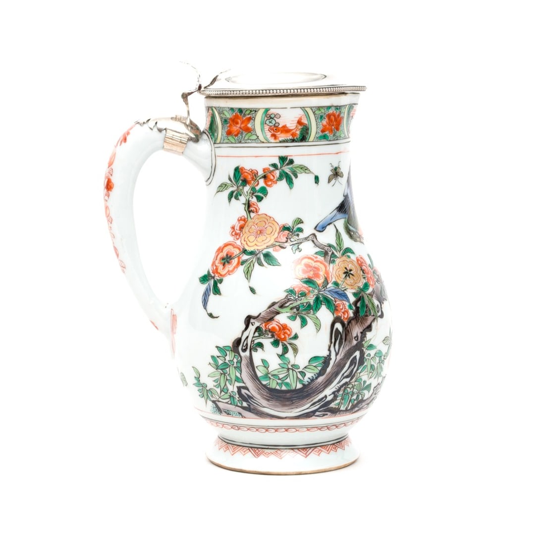 A 'Famille Verte' Porcelain Ewer With European Silver Plate Mounts China, Qing Dynasty, Kangxi: This elegantly proportioned porcelain ewer is brilliantly decorated in the famille verte palette, featuring vibrant translucent enamels including shades of green, iron-red, yellow, and manganese, furt
