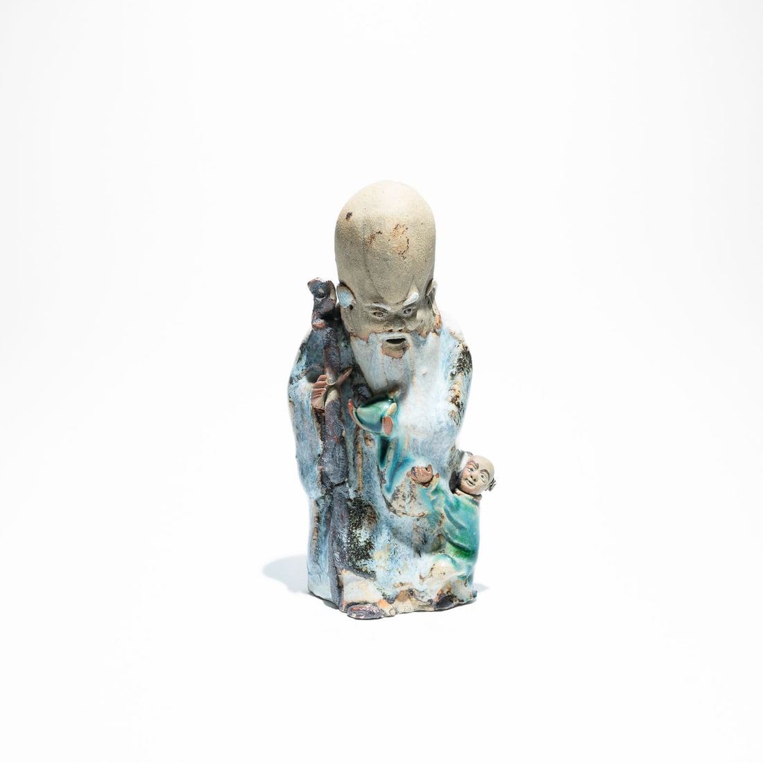 Shekwan ceramic figurine of Shou Lao, "Mudmen" late 19th Century: Shou Lao, the Chinese God of Longevity and one of the "Three Star Gods" (Sanxing). He is easily recognized by his exceptionally high, bulging forehead, which symbolizes wisdom and a long life. He is o