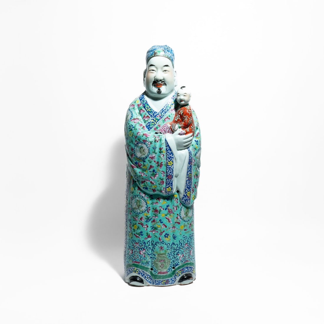 Chinese porcelain statue representing Lu Xing, one of the deities of the popular Sanxing triad: Lu Xing is the god of prosperity, status, and influence. He is traditionally depicted holding a child, which symbolizes the blessing of many offspring and the continuation of the family line. The stat