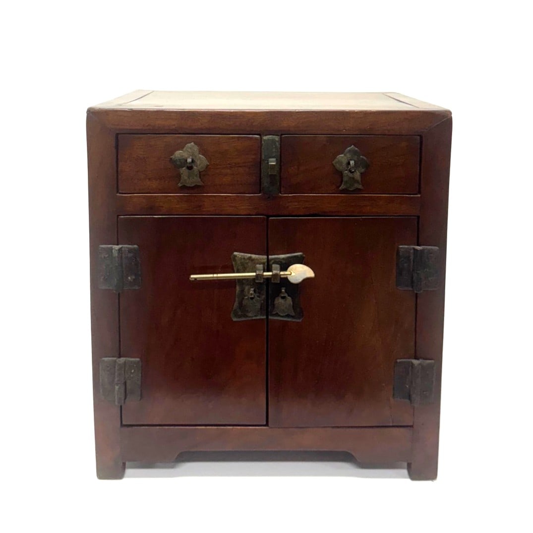 A small chinese hardwood table cabinet (Guì) China,Late Qing Dynasty,19th Century: Hardwood (likely Hongmu or Jichimu), with brass hardware fittingThis compact, rectilinear cabinet, designed to rest atop a table or desk, is an excellent example of 19th-century Chinese furniture inte