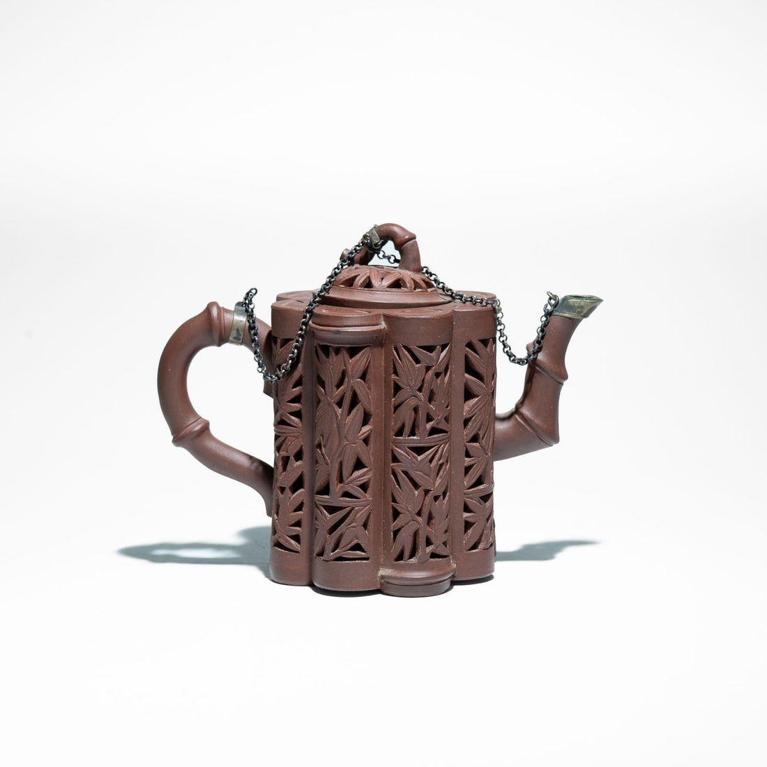 Yixing clay teapot (宜兴紫砂壶) Circa 1725: Specifically recognized in Chinese ceramic tradition as an Eight-Bamboo Linglong Teapot (清玲珑八竹壶).It is crafted from the famous Zisha (purple clay) from the Yi