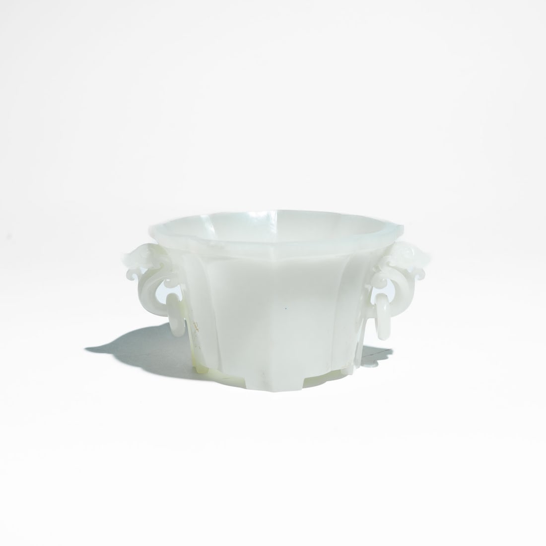 A carved Pale Celadon and White Jade Mallow-Shaped Cup China, Republic Period (1912–1949) or: A beautifully carved pale celadon and off-white jade cup of elegant foliate form, modeled with scalloped fluting resembling a mallow flower (kuihua).The vessel features deeply lobed