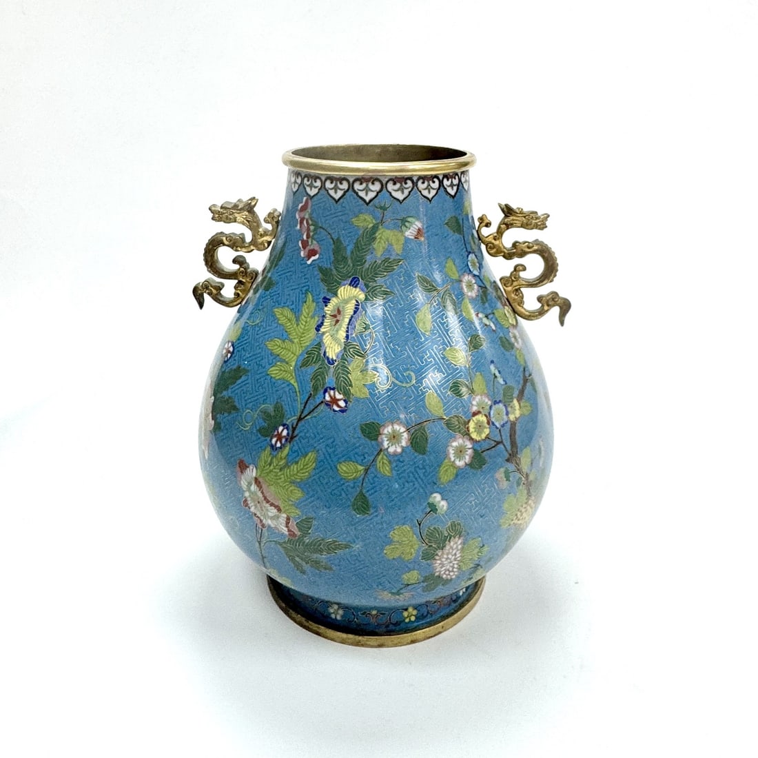 A gilt bronze and cloisonne enamel "HU" vase China, Qing dynasty, Jiaqing period (1796–1820): Of pear-shaped form rising from a short spreading foot to a flared neck and a gilt-rimmed mouth, the exterior meticulously enamelled in vibrant tones of red, yellow, white, green, and blue with an ele