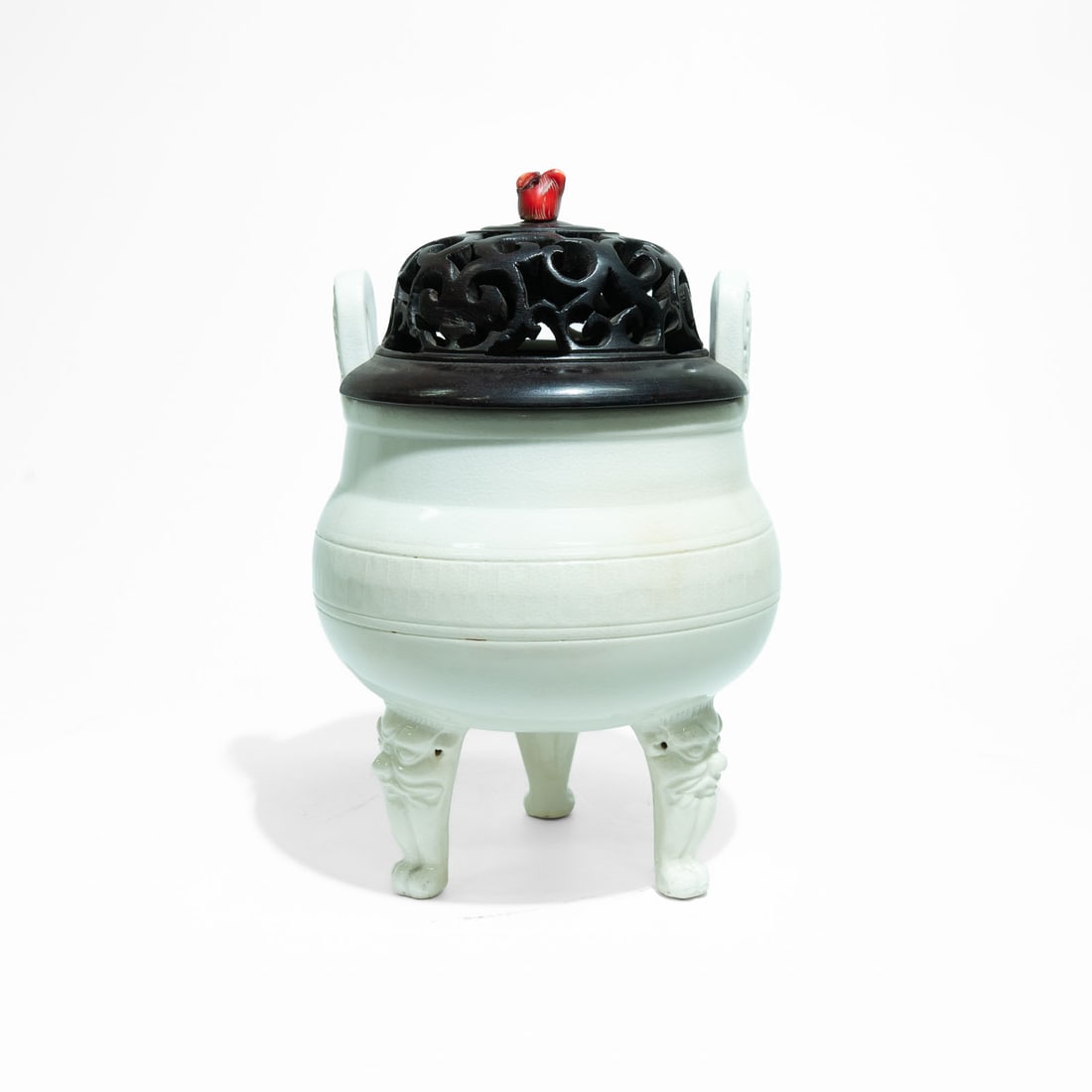 A Monochrome white soft-paste "Ding" tripod censer. China, Qing Dynasty, Kangxi Period (1662–: An elegant and rare monochrome cream-white soft-paste (huashi) porcelain tripod incense burner, Ding.The compressed globular bo