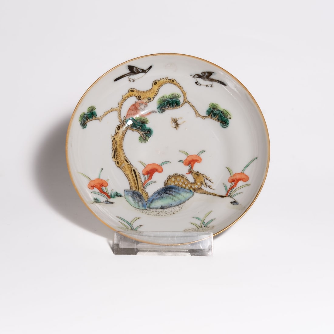 A Famille Rose 'Monkey and Deer' Dish China, Qing Dynasty, 19th Century: A porcelain dish of circular form with a shallow, flared well rising from a short, tapered footring. The interior is delicately painted in a vibrant Famille Rose palette with a narrative pastoral scen