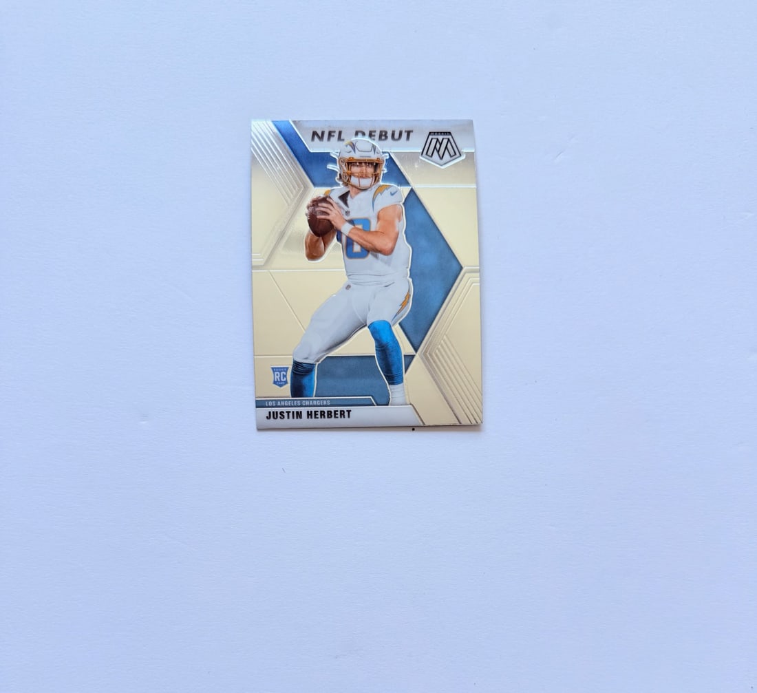 2020 Panini Mosaic NFL Debut Justin Herbert Rookie Card RC Los Angeles Chargers: 2020 Panini Mosaic “NFL Debut” Justin Herbert Rookie Card featuring the star Chargers quarterback during his breakout rookie season. One of the most collected modern NFL rookie cards from the 
