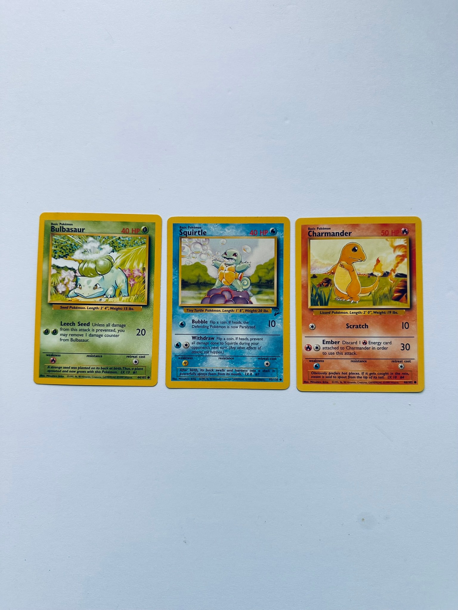 Pokemon Base Set Starter Lot (Bulbasaur 44/102, Squirtle 63/102, Charmander 46/102): Pokemon Base Set starter trio lot featuring Bulbasaur, Squirtle, and Charmander vintage collectible cards.