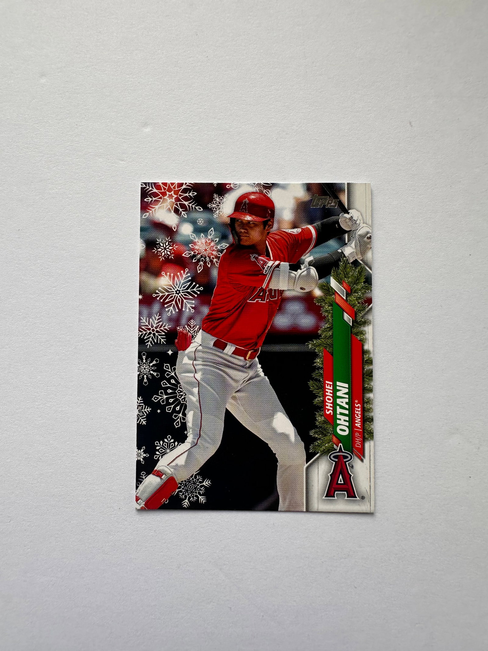 2020 Topps Holiday HW26 Shohei Ohtani Los Angeles Angels: Topps Holiday base card featuring Shohei Ohtani, one of baseball's premier modern stars and two-way players with the Angels.
