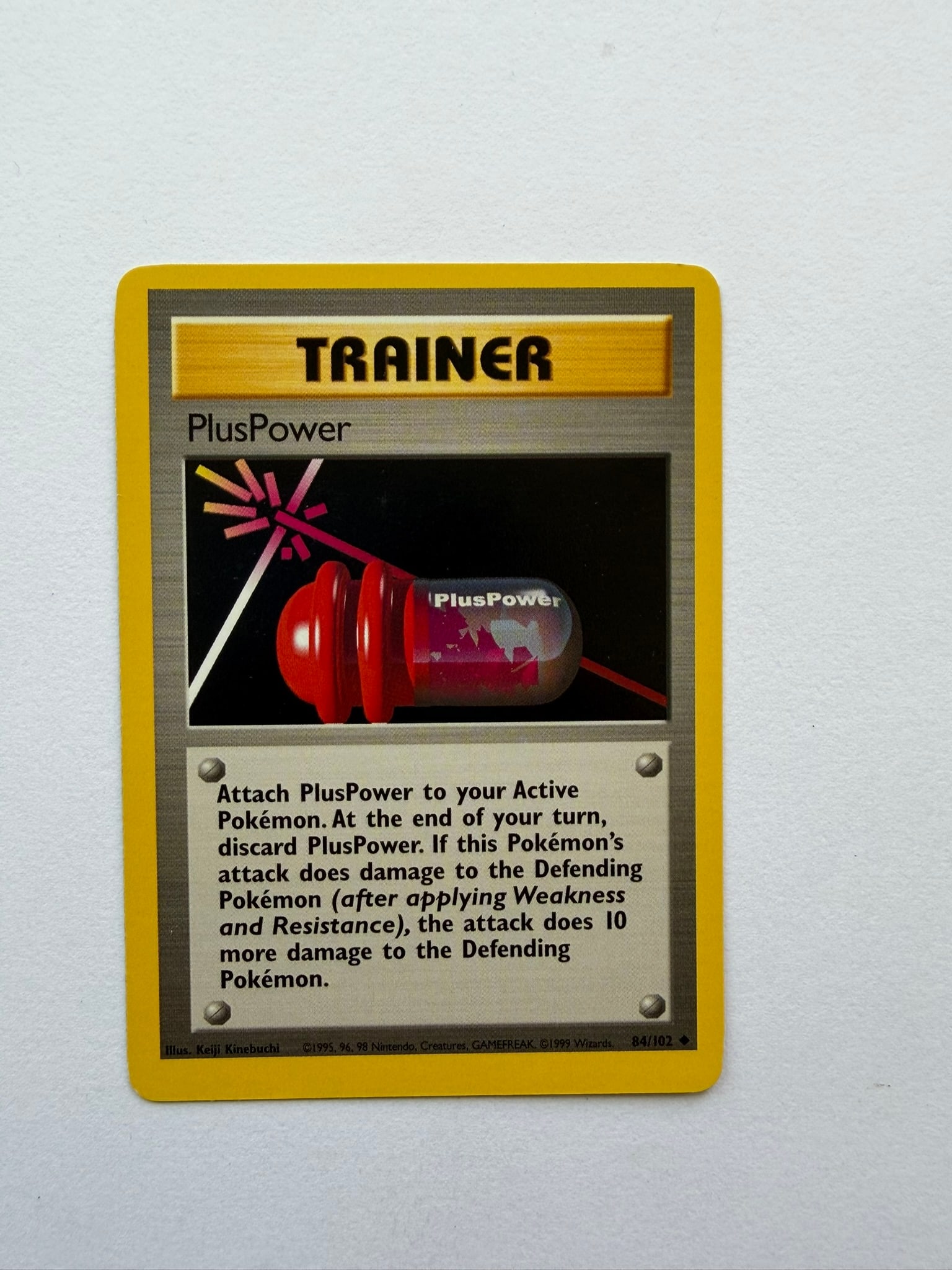 1999 Pokemon PlusPower 84/102 Base Set Trainer: Vintage PlusPower 84/102 Trainer card from the original 1999 Pokemon Base Set. Unlimited non-holo printing featuring Keiji Kinebuchi artwork. Ungraded with visible age-related wear. Please review phot
