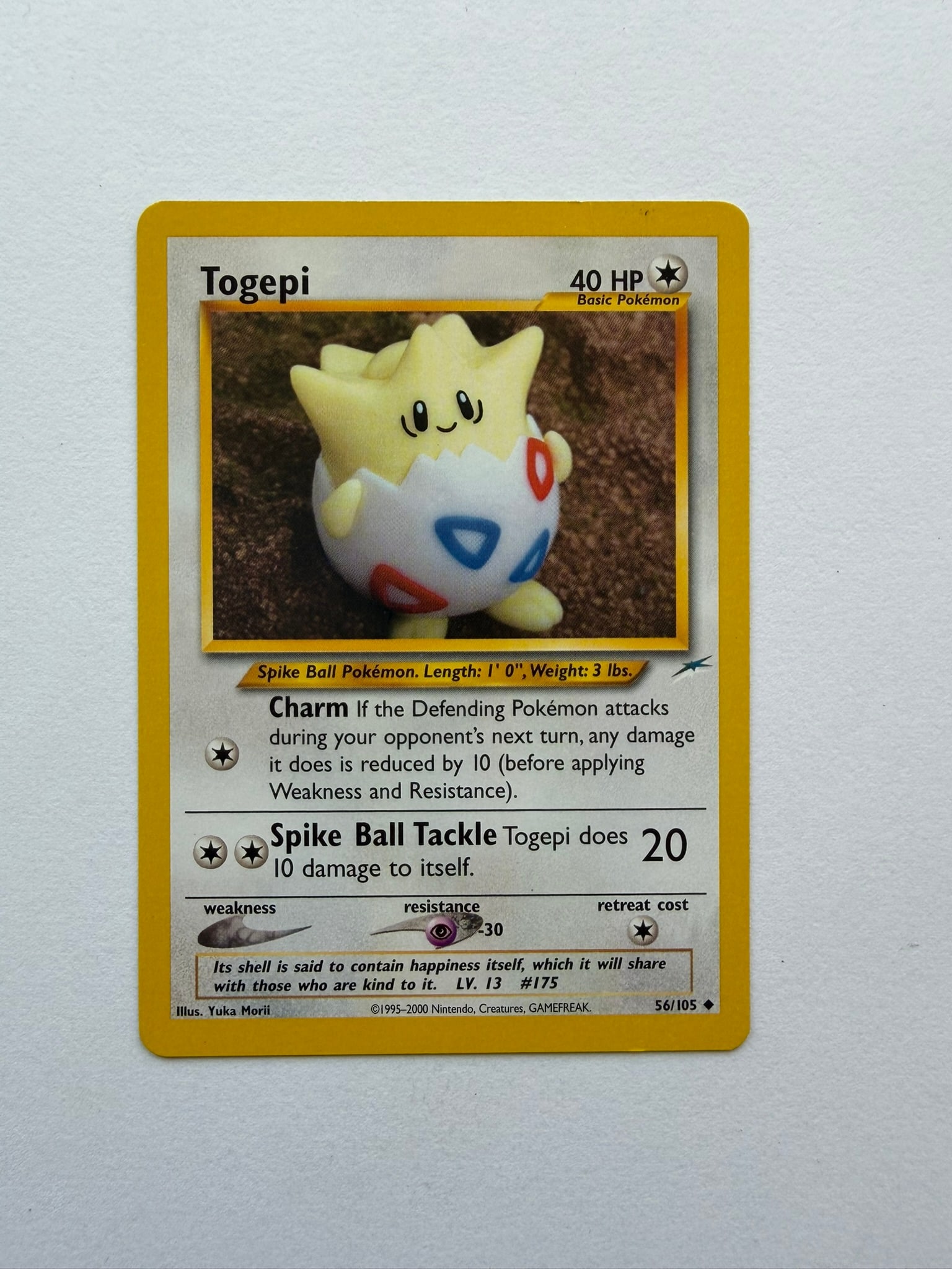 2002 Pokemon Togepi 56/105 Neo Destiny: Vintage Togepi 56/105 from the 2002 Neo Destiny expansion. Unlimited non-holo card featuring the popular clay-style artwork of Yuka Morii. Ungraded with visible edge and surface wear.